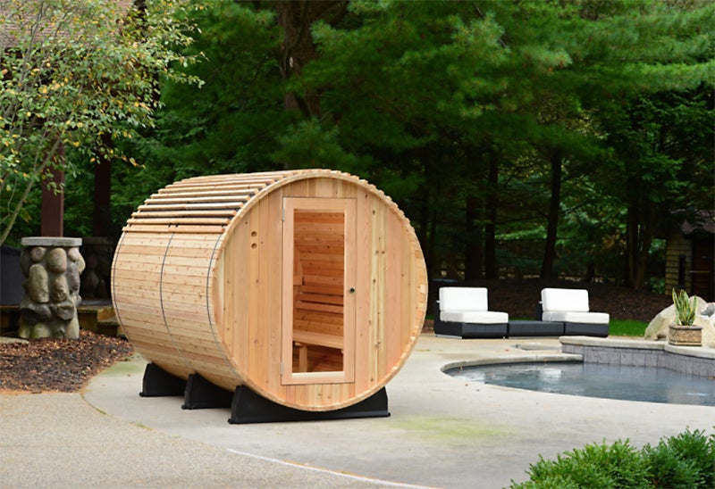 Almost Heaven Saunas' six-person Princeton barrel sauna installed next to an outdoor pool.